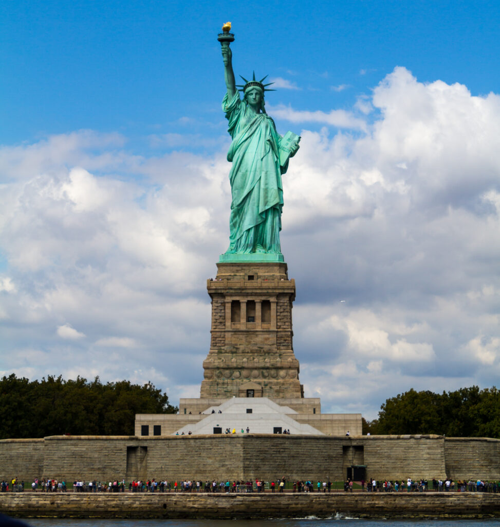 Front view of the Statue of Liberty holding the torch above New York Harbor