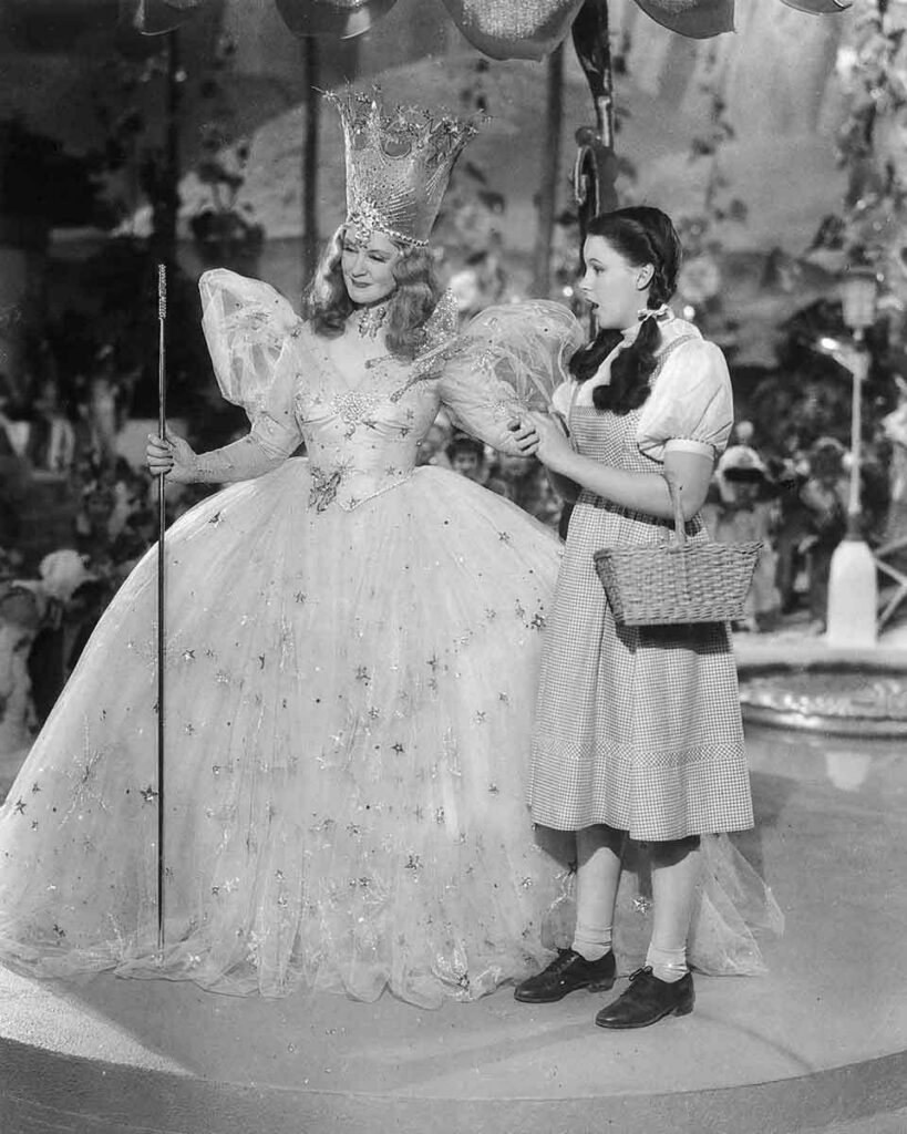 1939 MGM promotional photograph of Billie Burke as Glinda and Judy Garland as Dorothy in The Wizard of Oz.