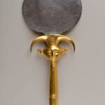 Ancient Egyptian silver mirror with a gold Hathor-emblem handle, New Kingdom, Dynasty 18.