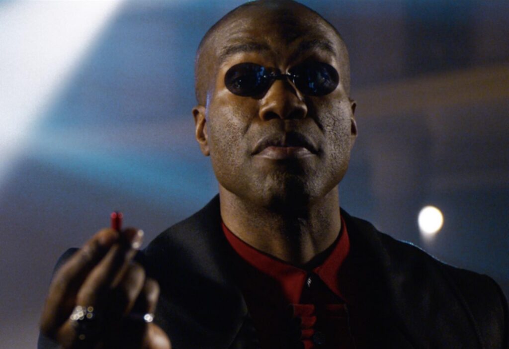 Laurence Fishburne as Morpheus holding the red pill in The Matrix (1999)