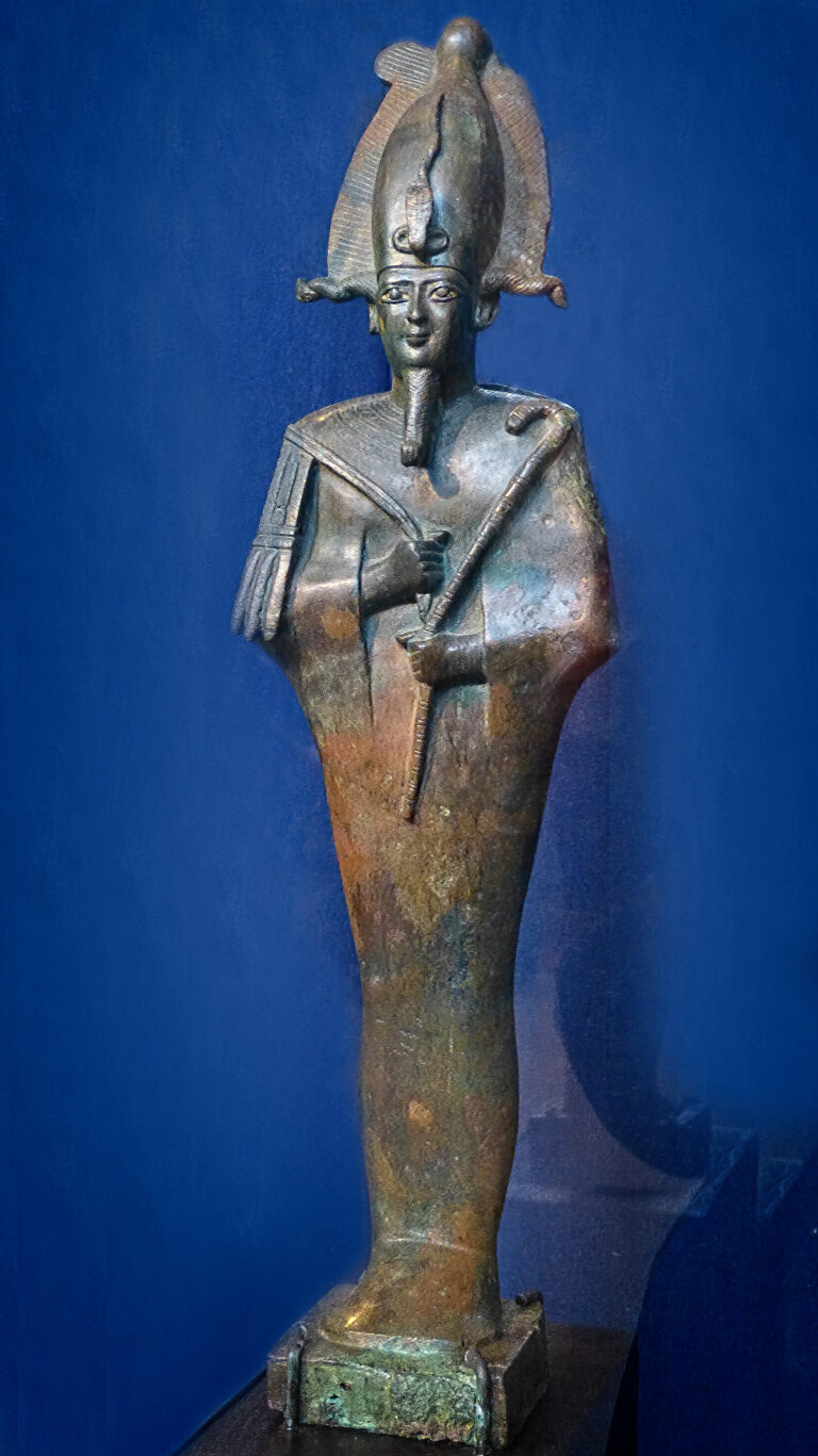 Bronze and gold votive statue of the Egyptian god Osiris wearing the atef crown and holding the crook and flail.