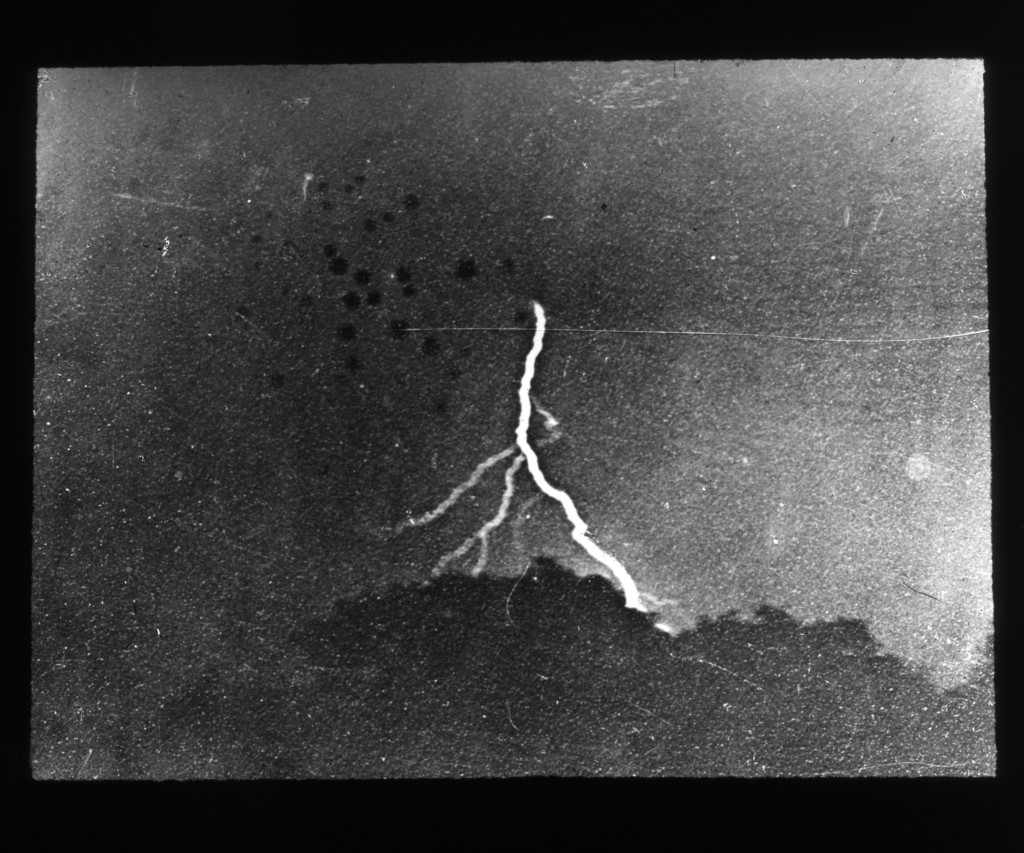 William N. Jennings's 1882 photograph of a branching lightning bolt above a dark horizon.
